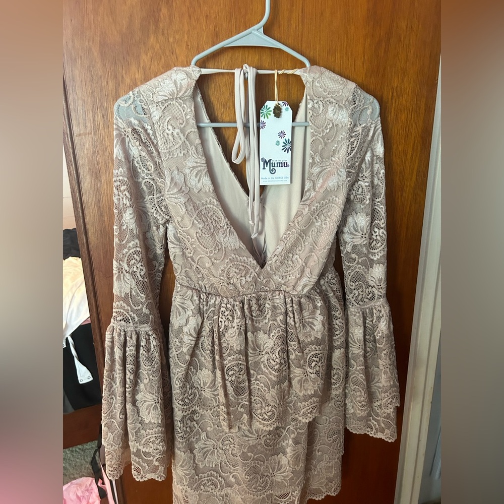 A Lacy cream colored dress, never worn, still has tags